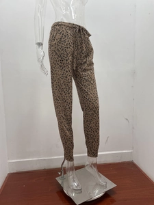 Detailed view of leopard print jogger pants with elastic drawstring waist and cuffed hems