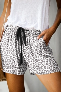 Detail of high waist leopard print shorts featuring elastic drawstring and side pockets