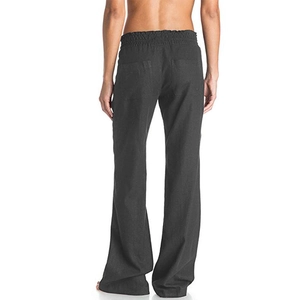 Back view of black cotton linen pants showing high waist and symmetrical patch pockets