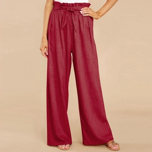 Detail of paperbag high waist with tie belt on burgundy linen wide-leg trousers