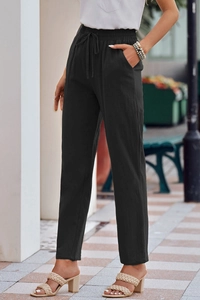 Detail view of black linen casual trousers featuring drawstring waist and side pockets