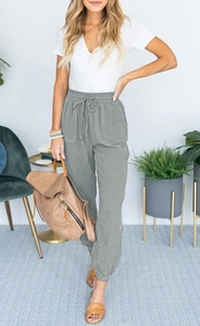 Detailed texture of gray cotton linen jogger pants with elastic drawstring waist and side pockets