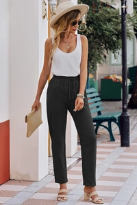 Detail of high-waisted black cotton linen trousers with adjustable drawstring waistband