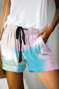Detail of summer high-waisted shorts featuring pink, white, and blue gradient and drawstring