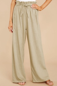 Detail of high waist linen wide leg pants with drawstring belt and ruffle trim