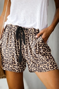 Detail of high waisted leopard print shorts with elastic drawstring and side pockets