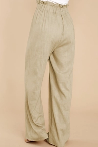 Detail view of khaki cotton linen pants showing elastic paperbag waist and fabric texture