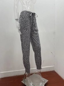 Detail of high-waisted leopard print joggers with adjustable drawstring and elastic cuffs