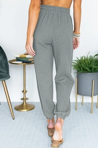Detail view of the elastic high waist and jogger cuffs on these casual gray pants