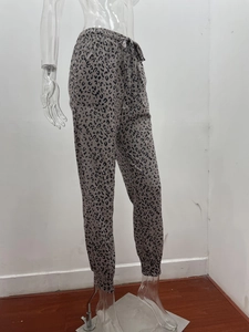 Detail of leopard print joggers featuring an elastic waistband with a drawstring closure