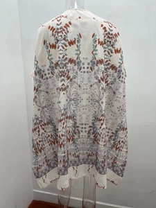 Détail de l'imprimé bohème sur ce gilet de plage d'été en mousseline blanche semi-transparente