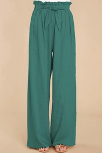 Close-up of high-waist paperbag trousers in dark green linen with self-tie belt detail