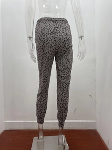 Detail view of khaki leopard print joggers featuring elastic waistband and cuffed ankles