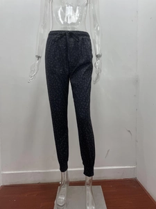 Detail of grey leopard print joggers featuring drawstring elastic waist and ribbed cuffs