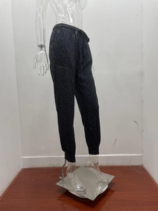 Detail view of leopard print jogger pants showing drawstring waist and side pockets