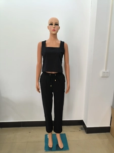 Détail d'un ensemble haut sans manches noir et pantalon à cordon sur mannequin