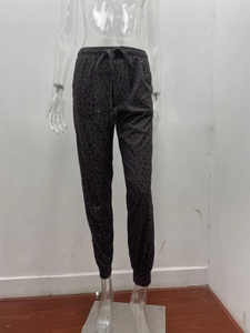 Close-up of leopard print joggers featuring drawstring elastic waist and cuffed ankles
