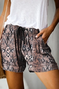 Close-up of summer shorts featuring snakeskin print, drawstring waist and side pockets