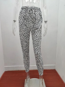 Detailed view of elastic waistband and adjustable drawstring on leopard print jogger pants