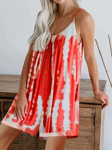 Detailed view of red and white tie-dye fabric texture with vertical pleats for summer wear
