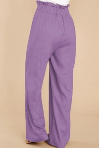 Detail of purple paperbag waist linen trousers featuring elastic high waist and frill trim