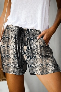 Detail of high waist snake print shorts with drawstring waist and rolled hem detail
