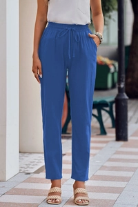 Detail of royal blue linen trousers showing elastic drawstring waist and side pockets