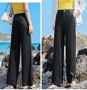 Viste dettagliate dei pantaloni larghi in lino nero a vita alta con taglio fluido