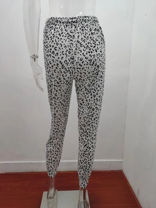 Detail view of elastic high waist and leopard print pattern on casual jogger pants