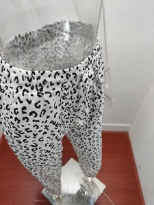 Detail of summer leopard print pants with drawstring waistband and bow tie