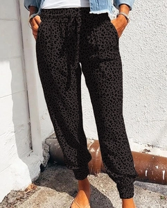 Detail of high waist leopard print joggers featuring adjustable drawstring and side pockets
