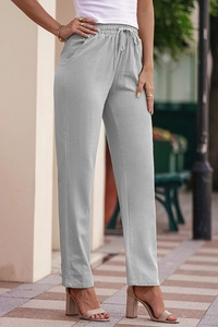 Detailed view of women's linen pants with elastic drawstring waist and side pockets