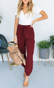 Detail of high waisted burgundy joggers with drawstring elastic waist and side pockets
