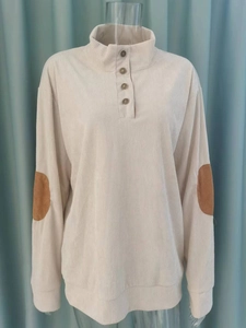 Detail of corduroy henley sweatshirt featuring brown faux suede oval elbow patches
