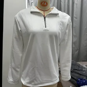 Close-up of white long sleeve sweatshirt featuring a half-zip stand collar and soft cotton blend