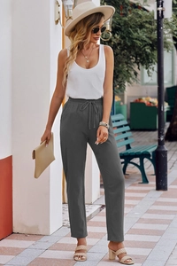 Detail view of charcoal grey linen trousers featuring elastic drawstring waist and natural texture