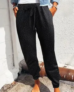 Detail view of black leopard print joggers with drawstring waist and elastic cuffs for women