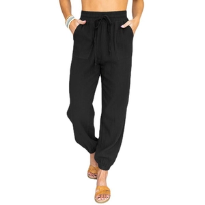 Detail view of black linen joggers featuring elastic drawstring waist and large patch pockets