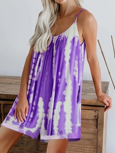 Detail of purple and white tie-dye fabric on loose summer jumpsuit with thin straps