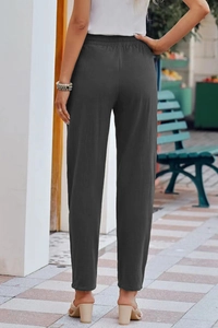 Rear view of women's dark grey cotton linen trousers with elastic waist in street style