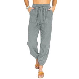Detail of grey high-waisted joggers with elastic drawstring waist and side patch pockets
