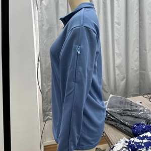 Detail view of the sleeve zipper pocket on a men's lightweight outdoor pullover sweater