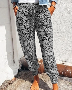 Detail of grey leopard print joggers featuring drawstring waist and side slant pockets