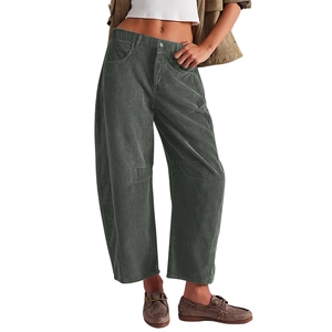 Close-up detail of dark green corduroy fabric texture and straight leg cut for women