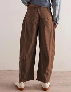 Detail view of high waist brown corduroy trousers showing rear pockets and fabric texture
