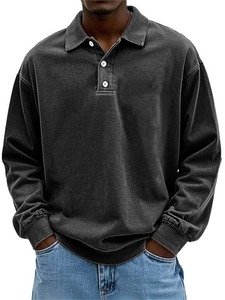 Detailed view of men's washed black long sleeve polo shirt with three-button placket