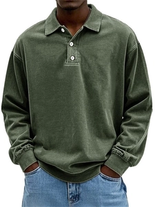 Detail of vintage washed olive green men's long sleeve polo shirt showing the textured fabric