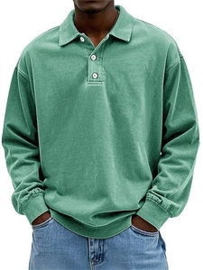 Close-up of vintage green long sleeve Polo shirt with white buttons and ribbed cuffs