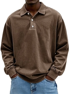 Detail view of coffee brown long sleeve polo shirt with three white contrast buttons