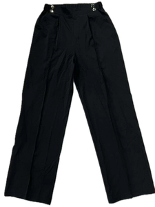 Detail view of high-waist black trousers featuring decorative silver side buckles